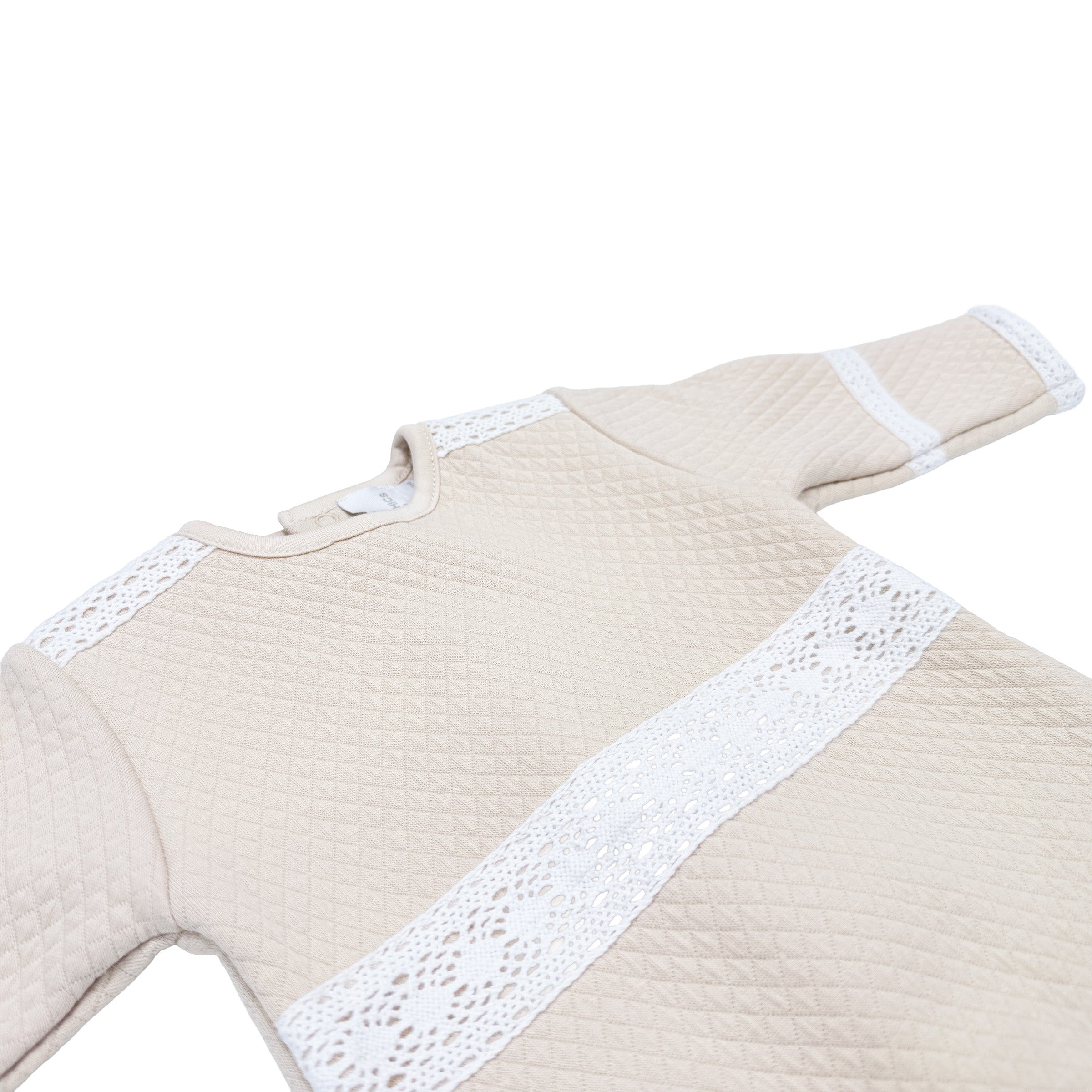 Close-up of lace panel on front of Cheris Ivoire Élégance Babygrow.