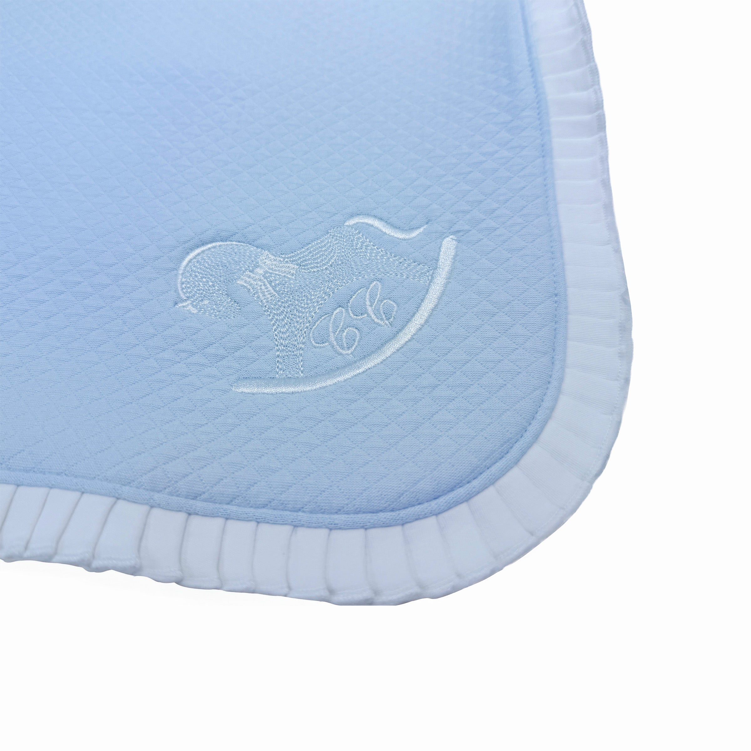 Close-up of frill border and embroidered motif on baby blanket. Signature logo embroidery.