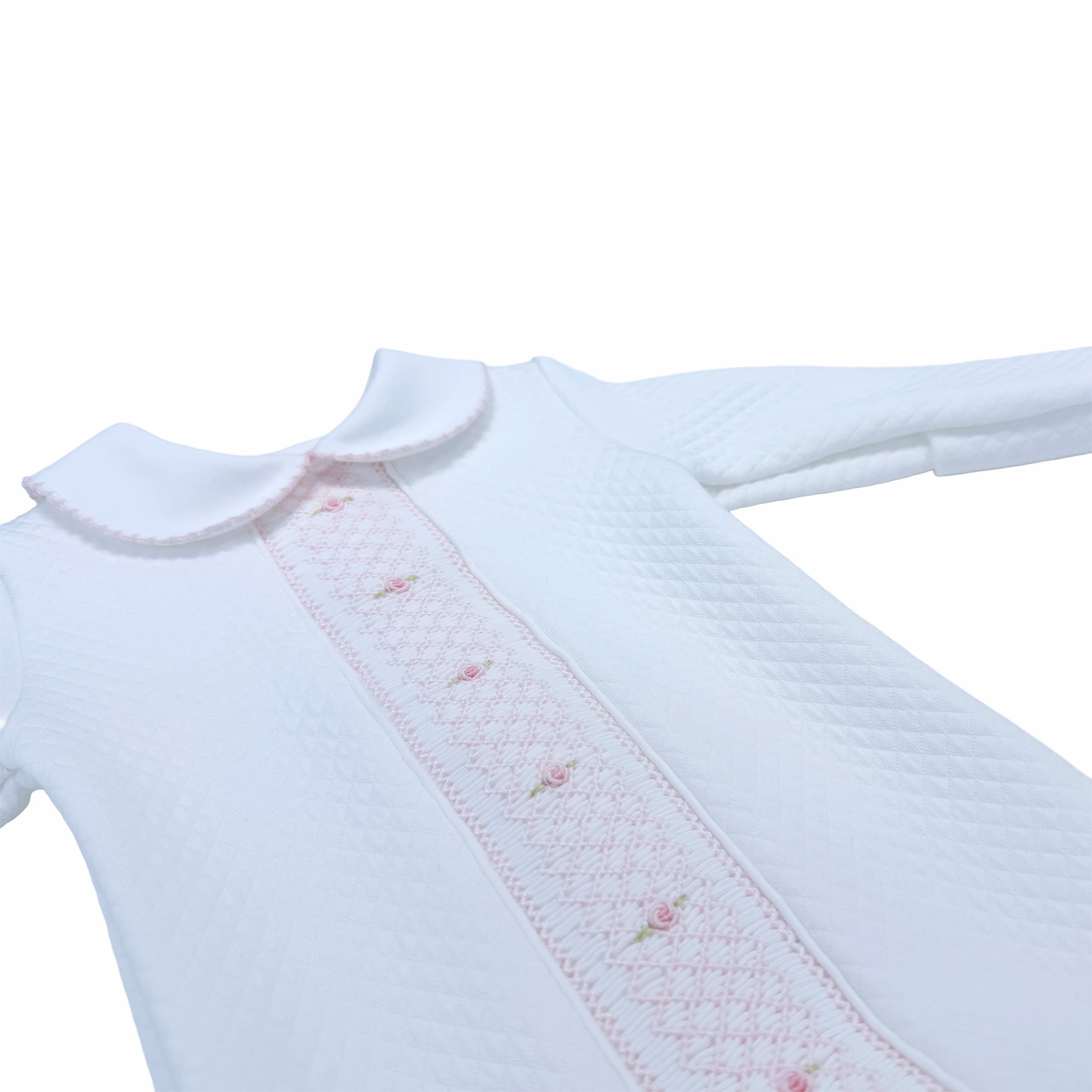 Close-up of the Heirloom-Stitched quilted texture on the Cheris Blanc Couture Babygrow.
