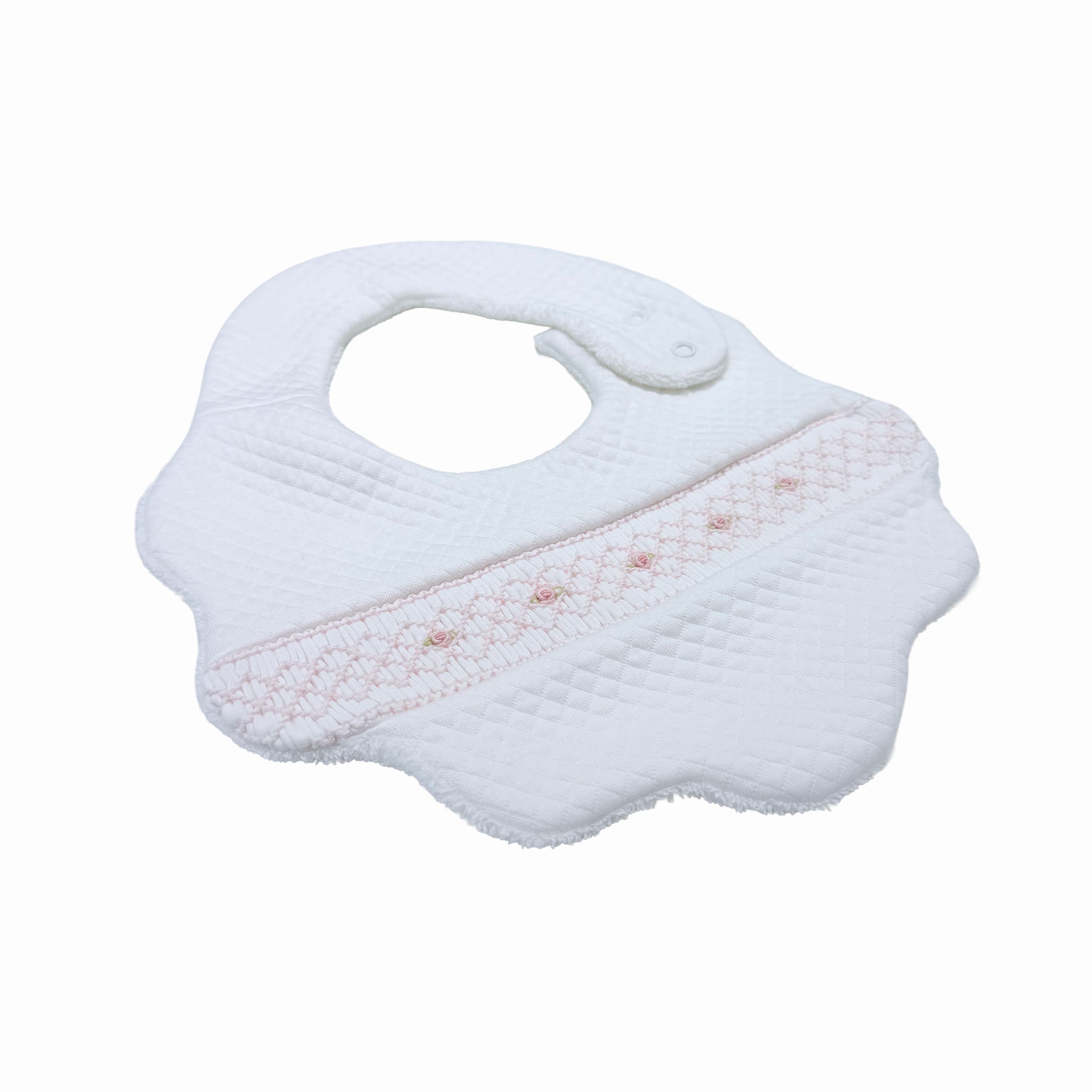 Front side view of white quilted baby bib with hand-smocked rosette detailing.