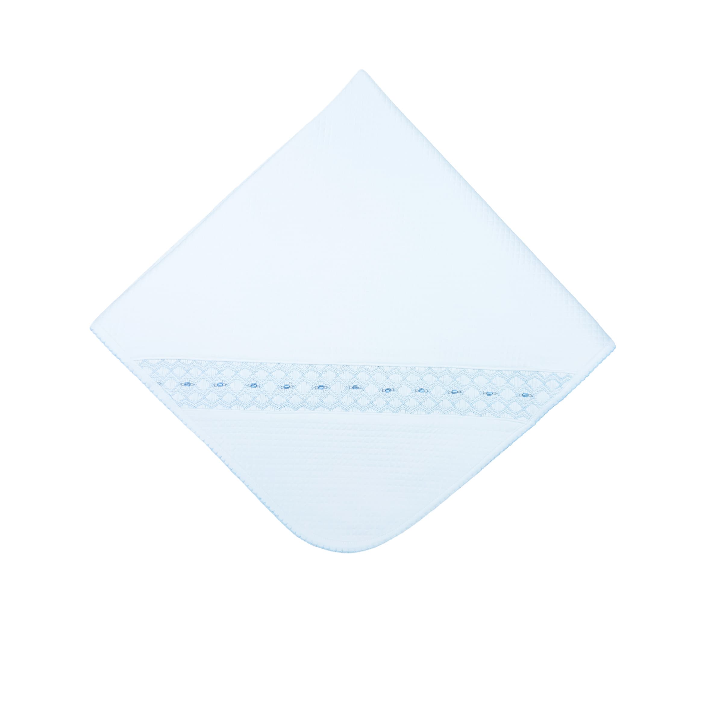 Quilted white Beau blanket with hand-smocked panel and artisanal embroidery — front view.