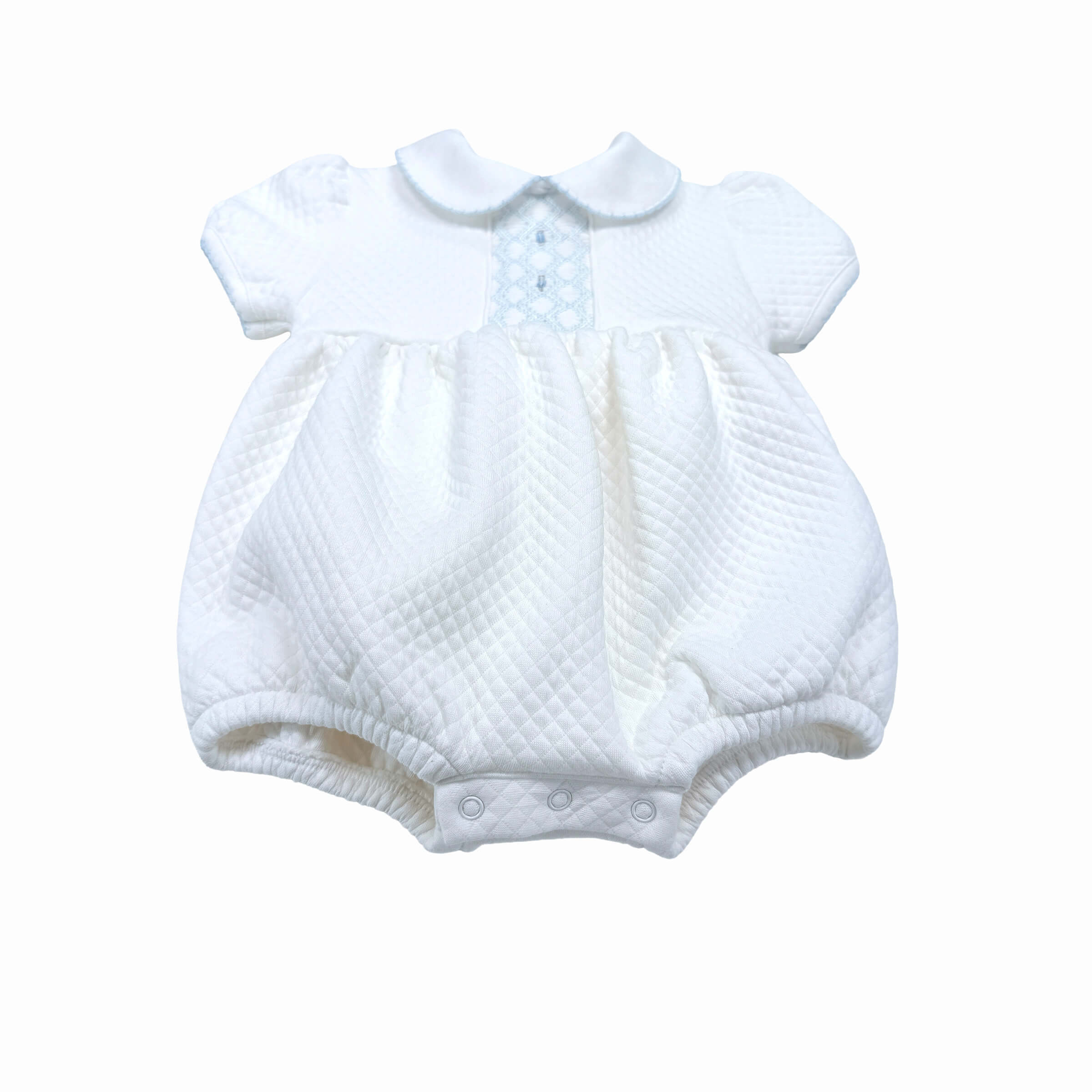 “Close-up of hand-smocked stitching and artisanal details on Beau bubble romper