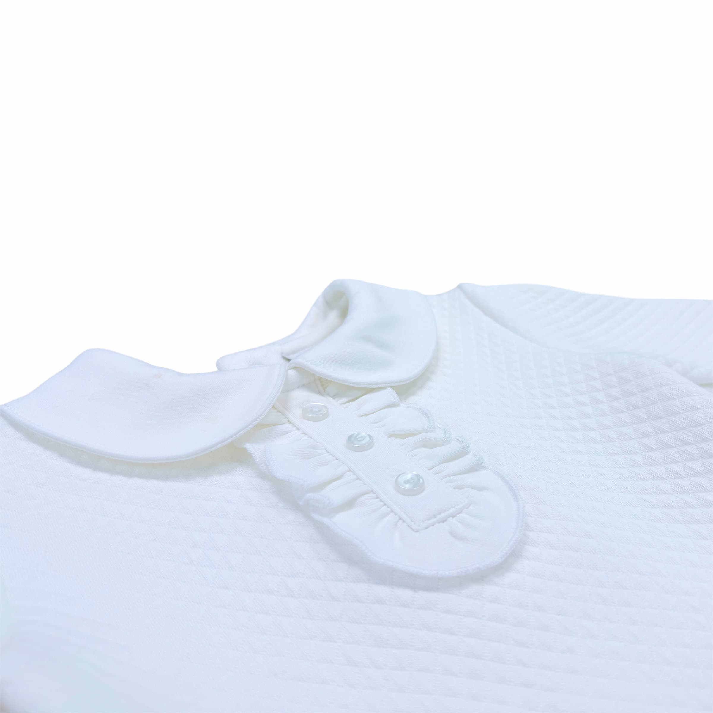 Close-up of the signature Chéris embroidery on the Élégance Ruffled Bodysuit, showing refined needlework.
