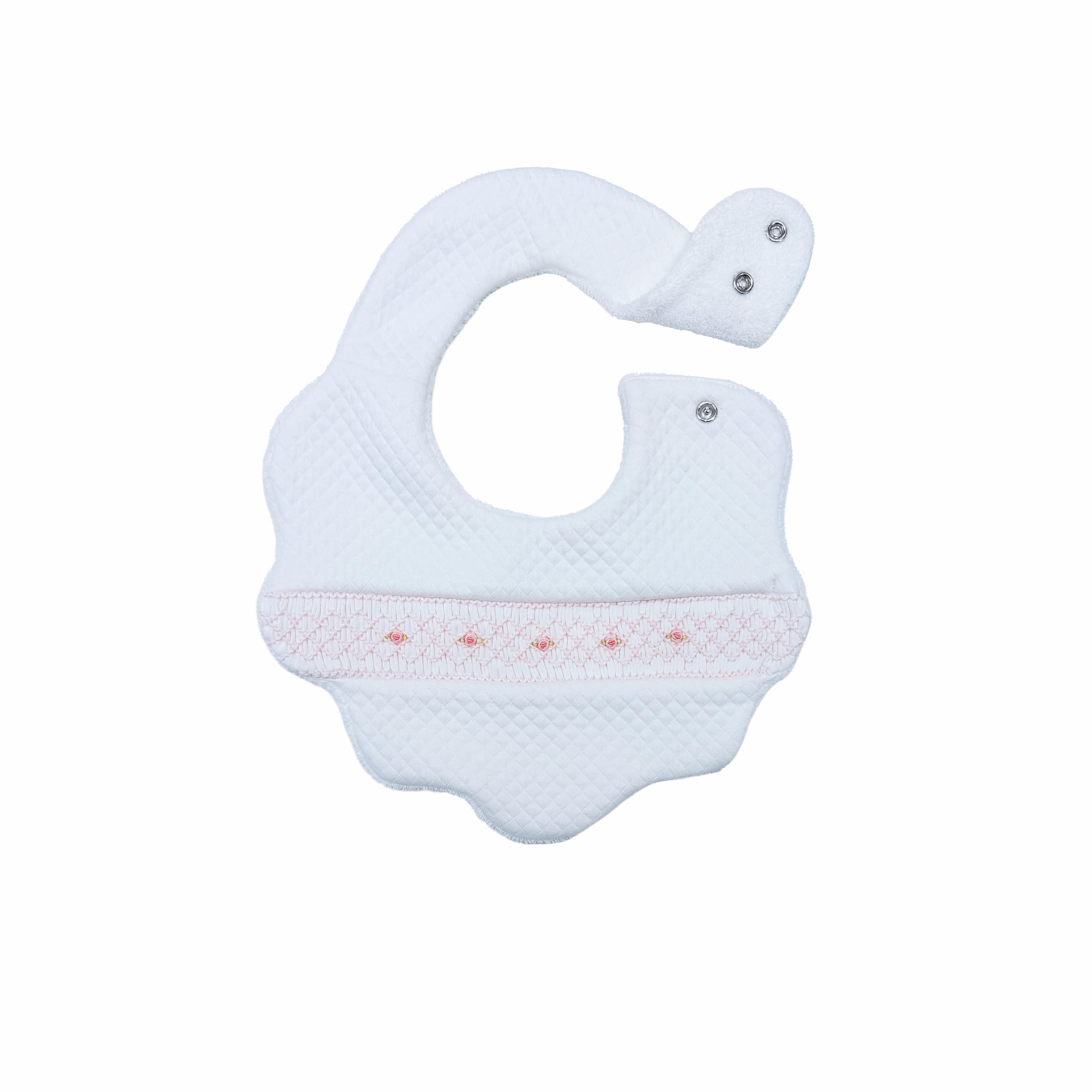 Front view of opening on white quilted baby bib with hand-smocked rosette detailing.