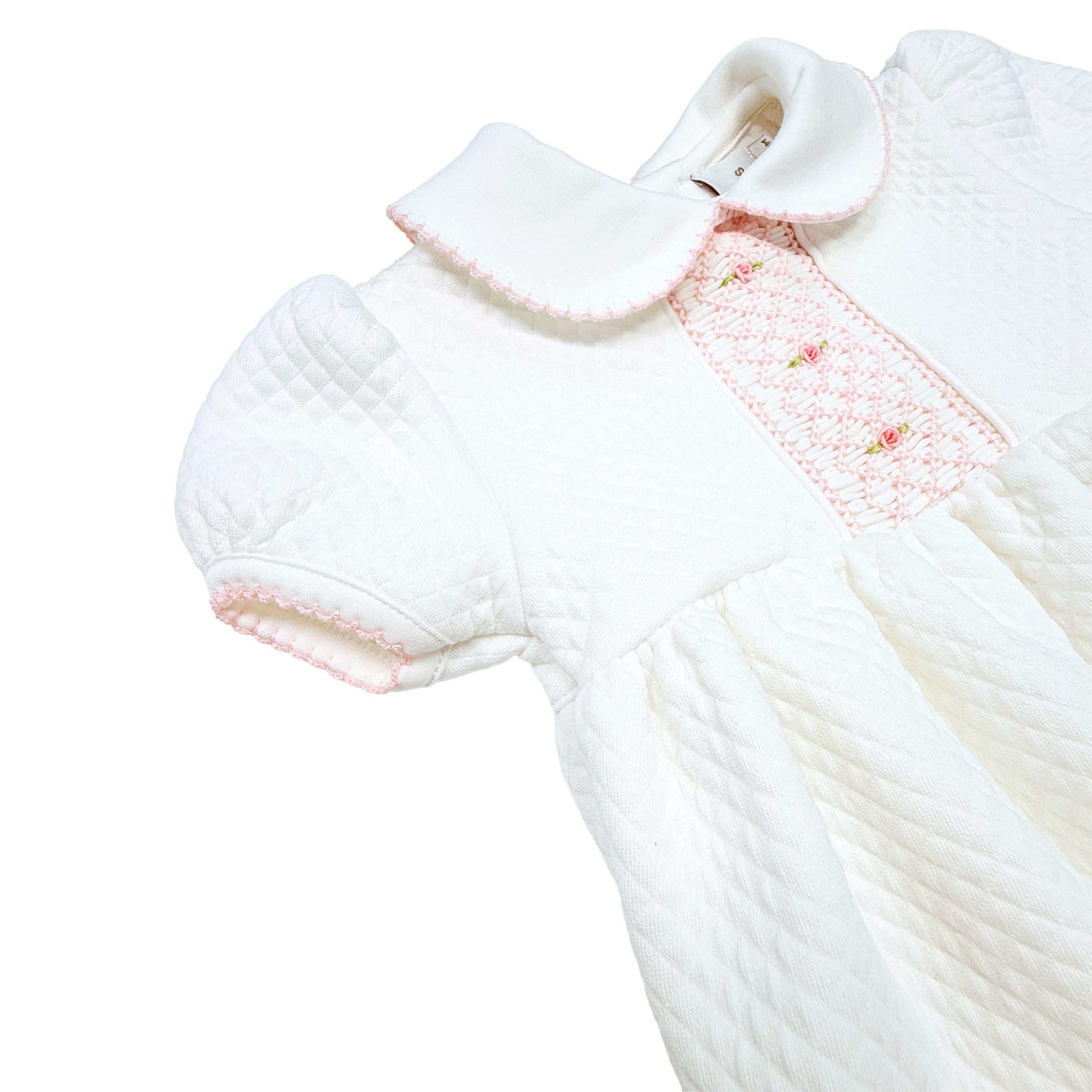 Hand-gauged smocking and rosette embroidery detail on Mademoiselle bubble romper.