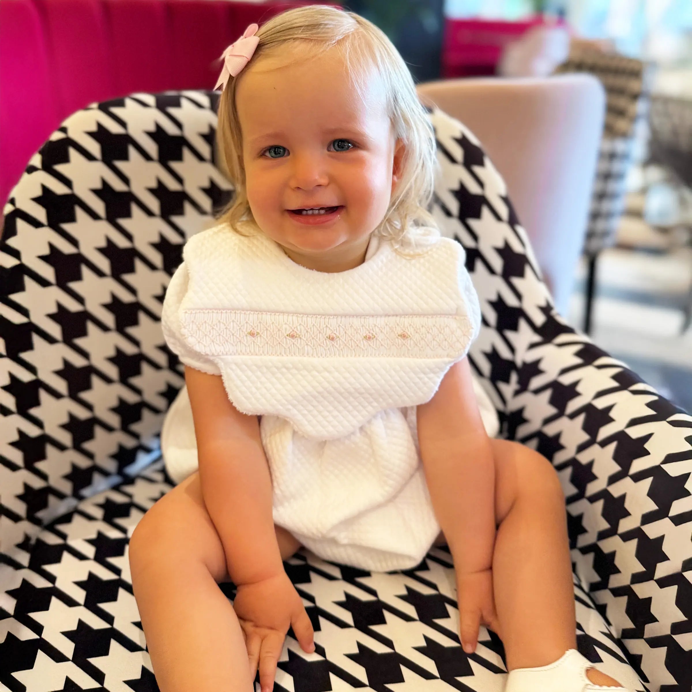Baby wearing Cheris Blanc Couture Mademoiselle bib styled with matching outfit.