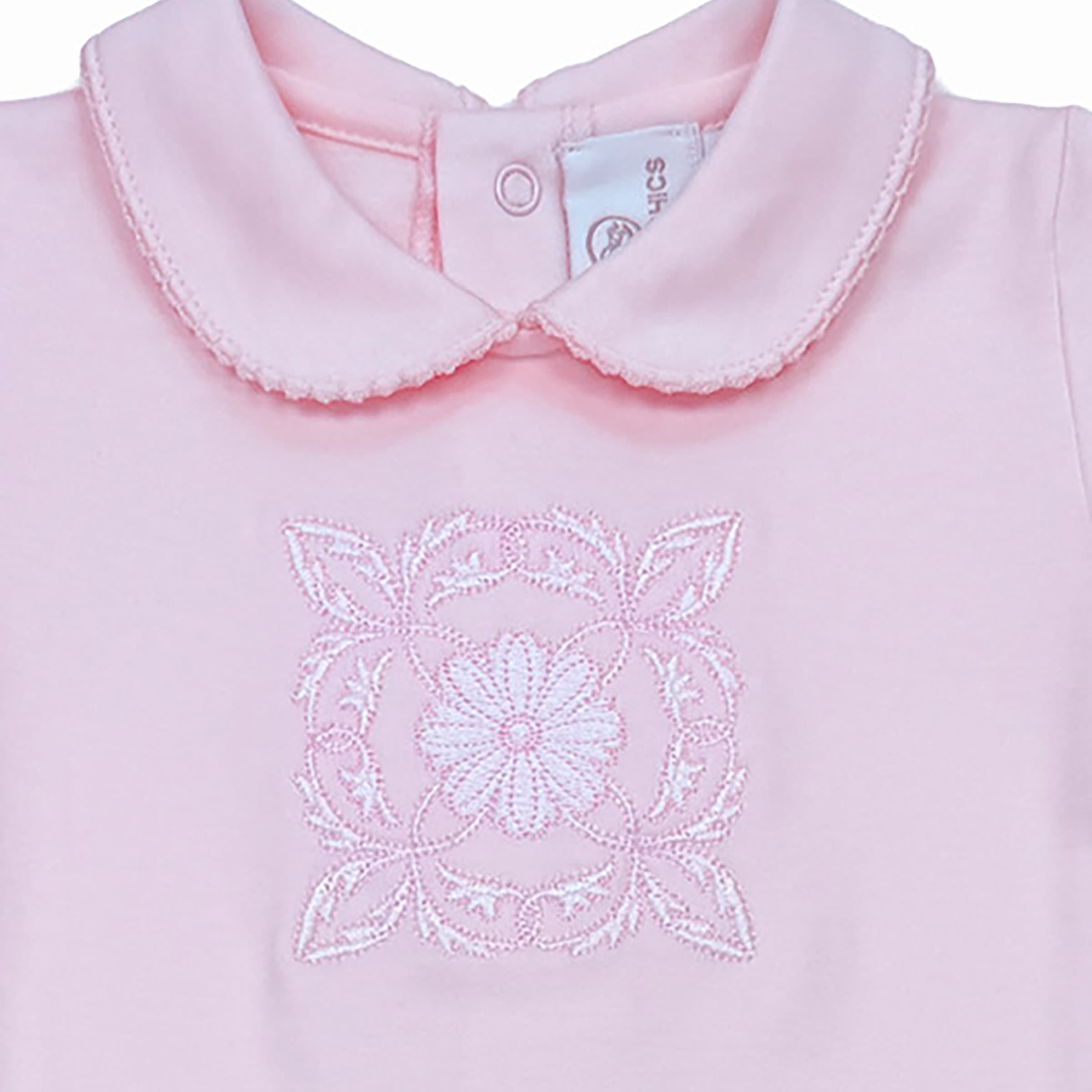 Soft rose interlock fabric texture and embroidery on luxury baby babygrow.