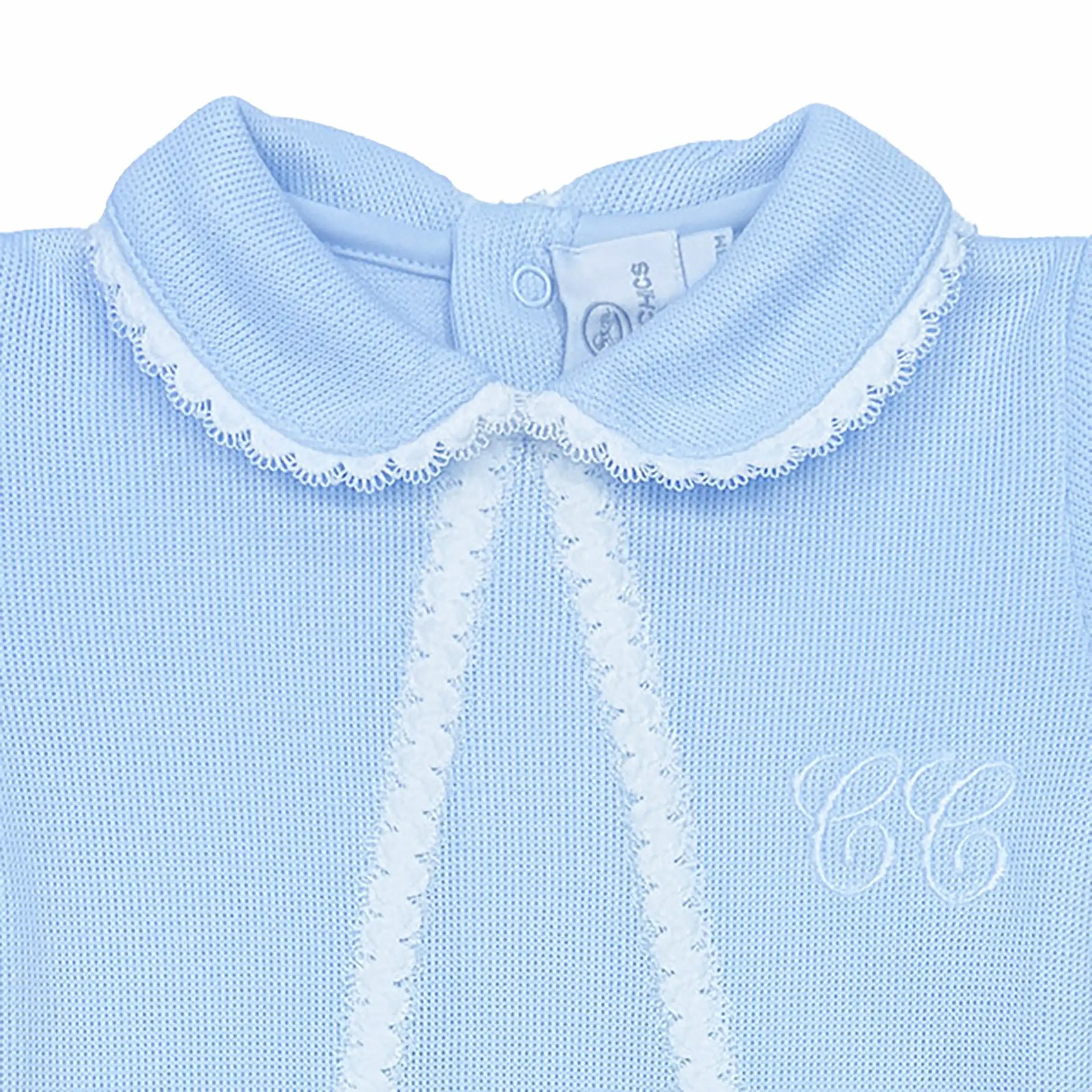 Close-up of embroidered detailing on luxury azur special-knit baby sleepsuit.