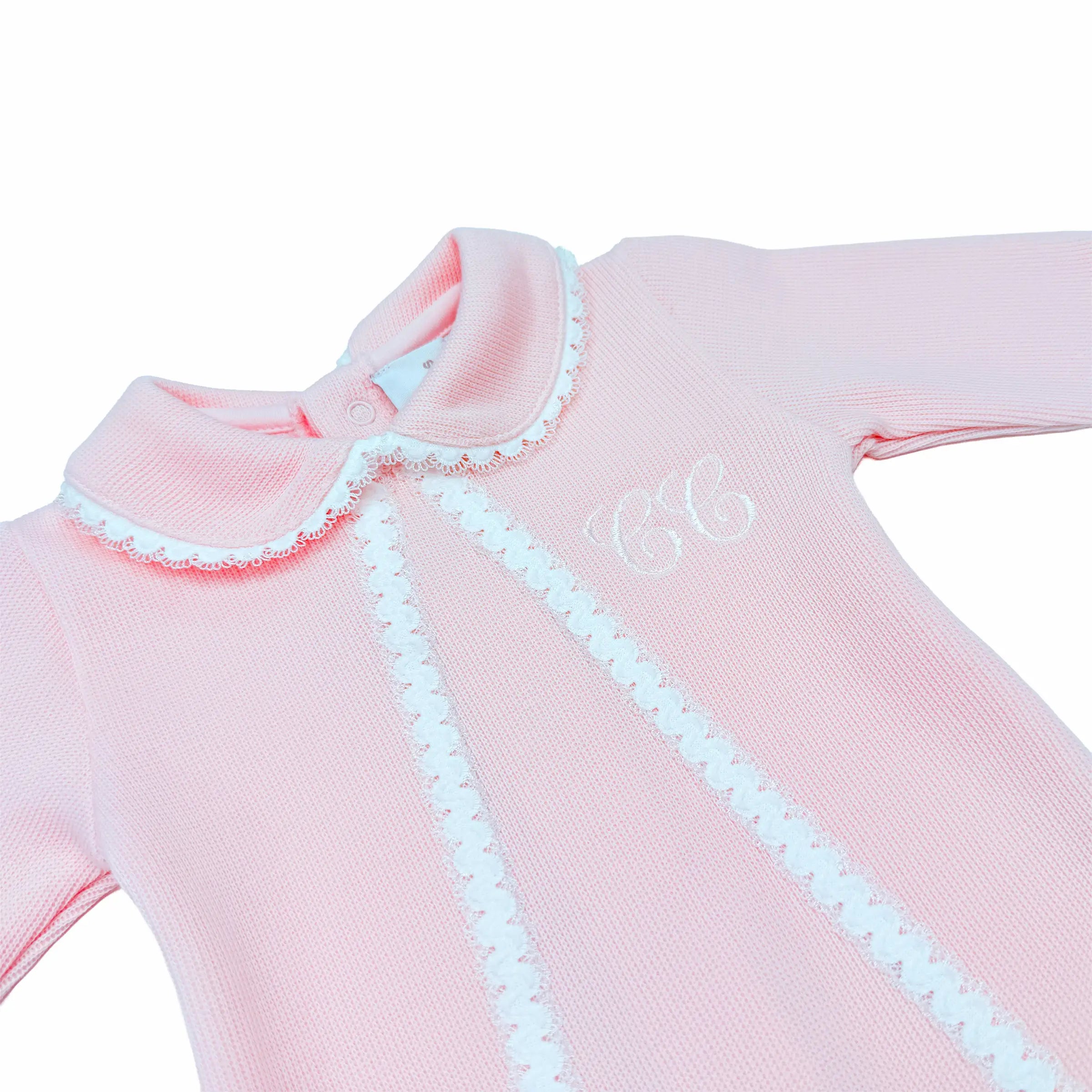 Detailed embroidery on luxury rose special-knit baby sleepsuit.