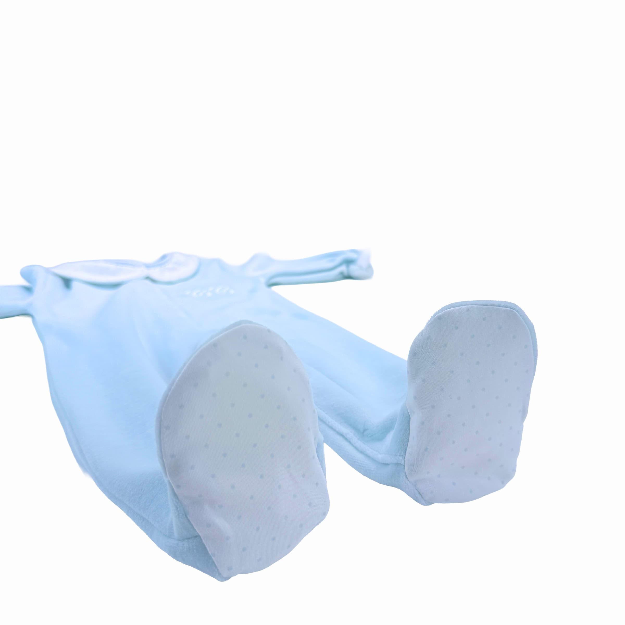 Coordinated patterned foot trims on saphir blue velour babygrow.