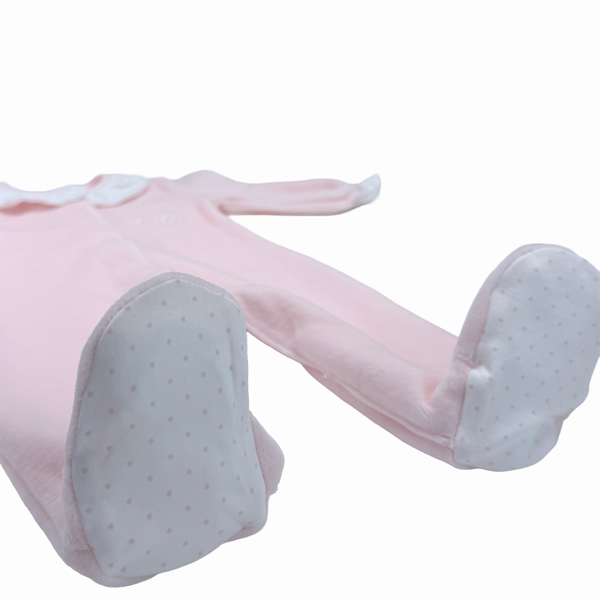 Patterned foot trims on rose velour babygrow – soft and refined finish.